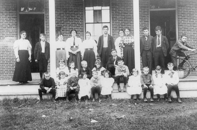 My grandfather, George Dinsmore Sr., on the far left, next to the teacher at the brick school house in Windham NH.